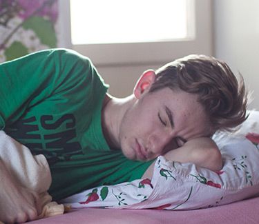 Boy sleeping on bed